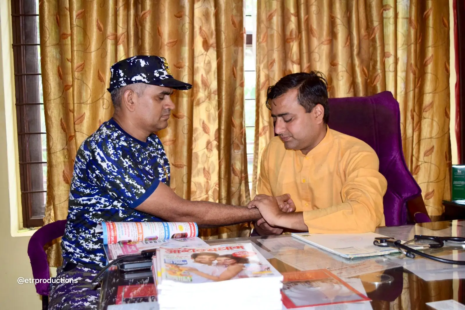 Yogi Dr. Amrit Raj examining a patient by pulse diagnosis during an Ayurvedic consultation at Arogyadham